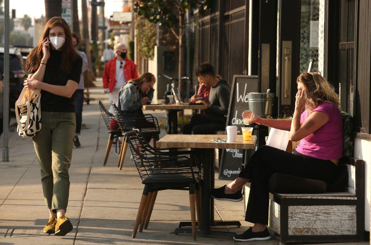 VENICE, CA - NOVEMBER 23, 2020 - People enjoy a meal and something to drink at Greenleaf restaurant  along Abbot Kinney Blvd. in Venice on November 23, 2020.  In a devastating blow to Los Angeles struggling restaurant and hospitality industry, L.A. County public health officials on Sunday announced they will suspend outdoor dining at restaurants amid a surge of new coronavirus cases.The new rule takes effect at 10 p.m. Wednesday and restricts restaurants  along with breweries, wineries and bars  to takeout and delivery only for the first time since May.  Venice on Monday, Nov. 23, 2020  Venice, CA. (Genaro Molina / Los Angeles Times via Getty Images)