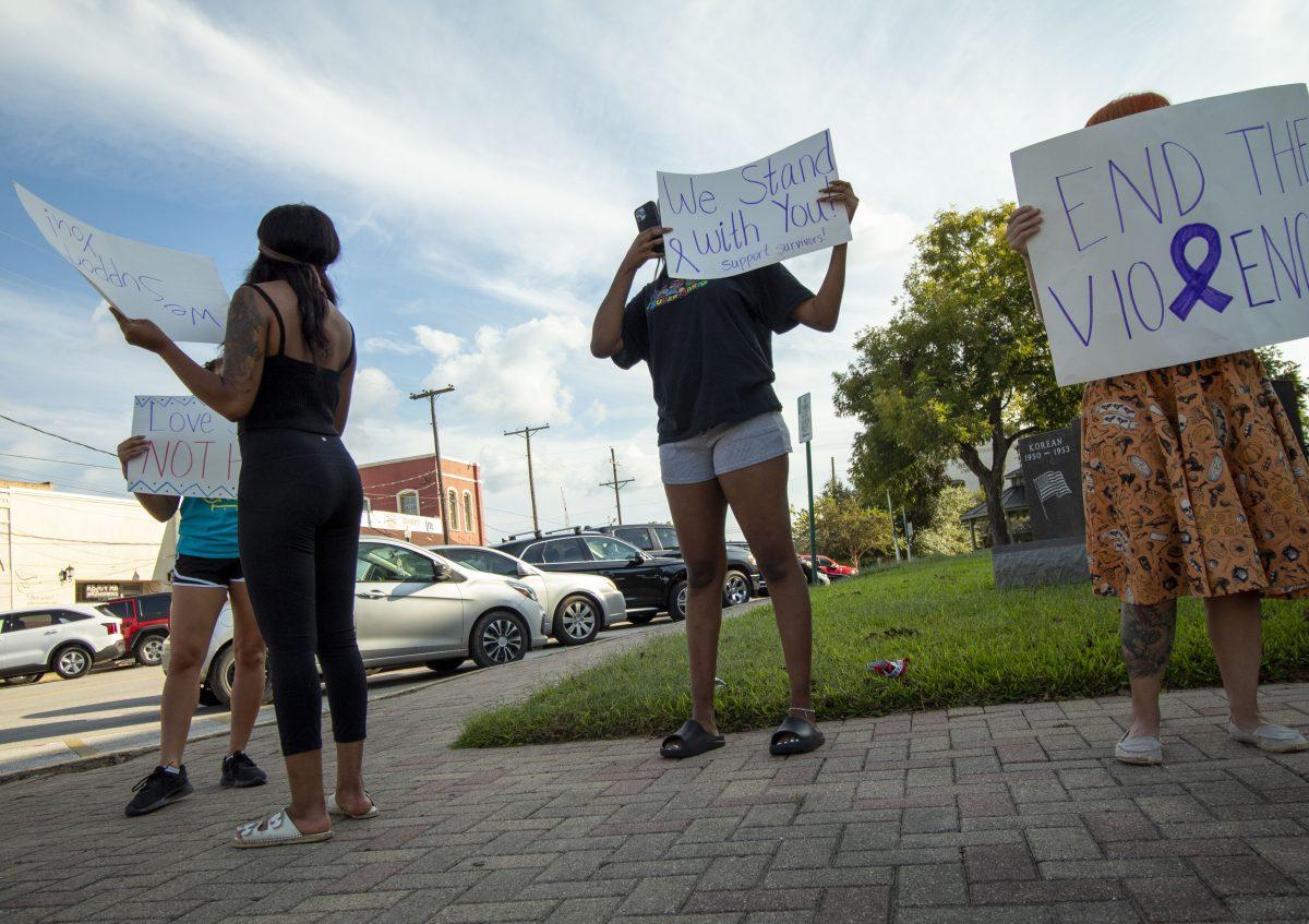 Community members rally outside courthouse to spread awareness of domestic violence