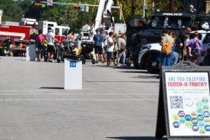 People line up looking at trucks at annual Touch-A-Truck