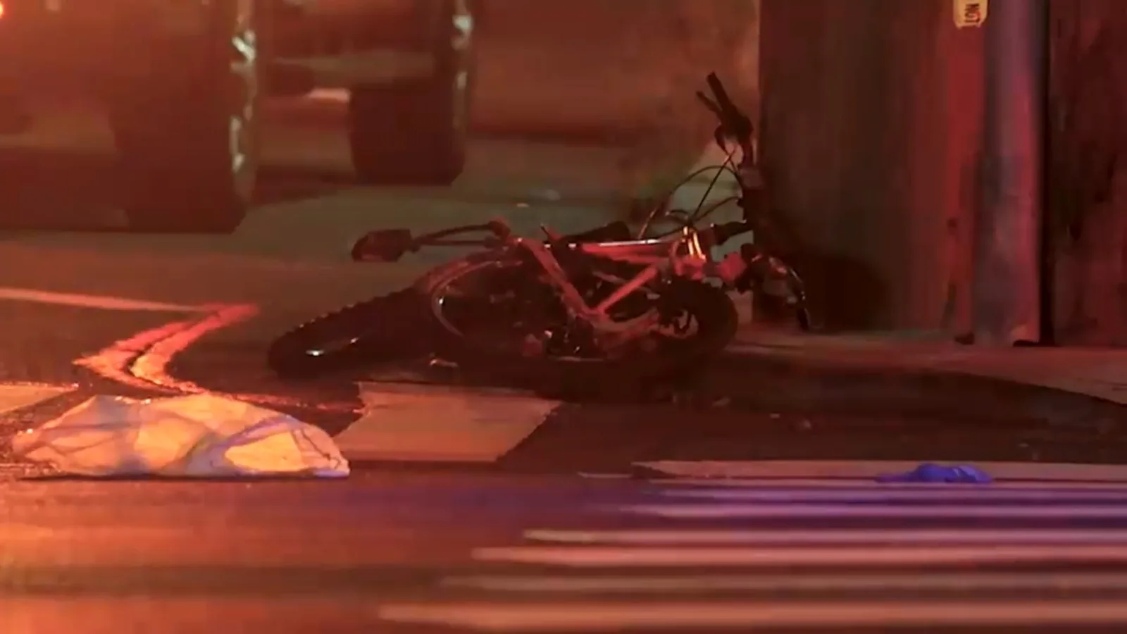 Police lights near a Staten Island roadway after a fatal collision involving a bicyclist and an ambulance