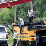Emergency crews work to right an overturned school bus after a fatal crash in Winter Haven Florida