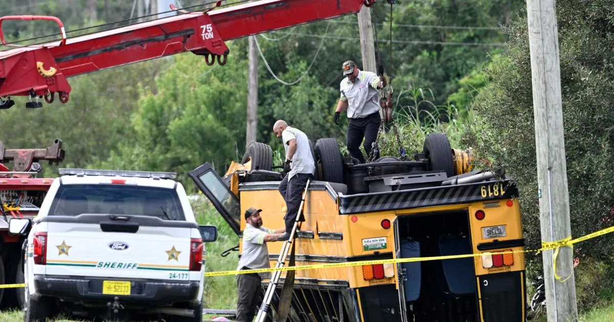 Emergency crews work to right an overturned school bus after a fatal crash in Winter Haven Florida