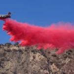 Smoke rises over Southern California hills as firefighters respond to brush fires during strong winds