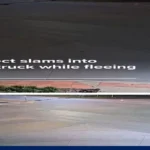 Traffic camera image of a car hitting a FedEx semi-truck at an Iowa intersection