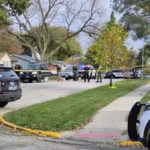 Ames police vehicle parked near a residential street during a homicide investigation