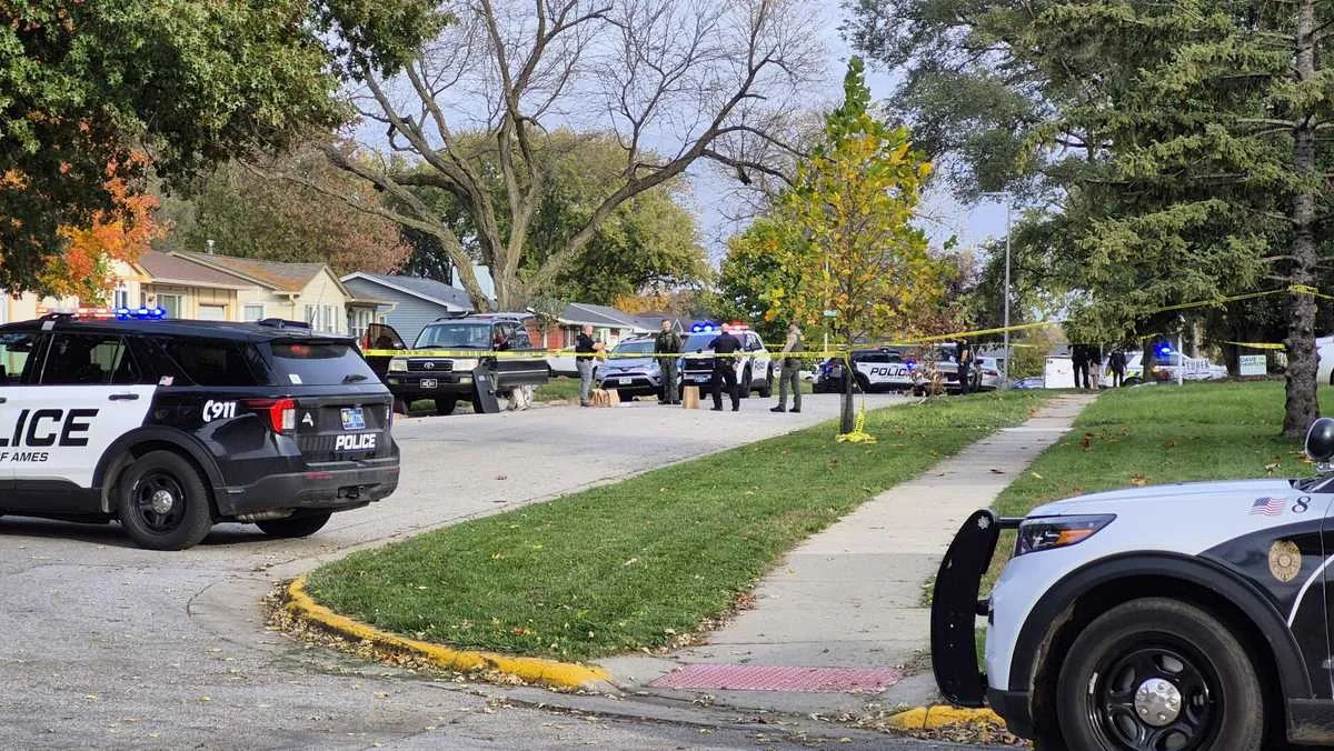 Ames police vehicle parked near a residential street during a homicide investigation