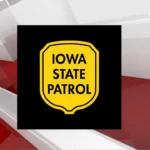 Emergency crews respond after a car hit a semi-trailer at a highway intersection in Osage, Iowa