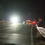A sheriff's vehicle near a roadway after a fatal crash investigation involving a coal truck