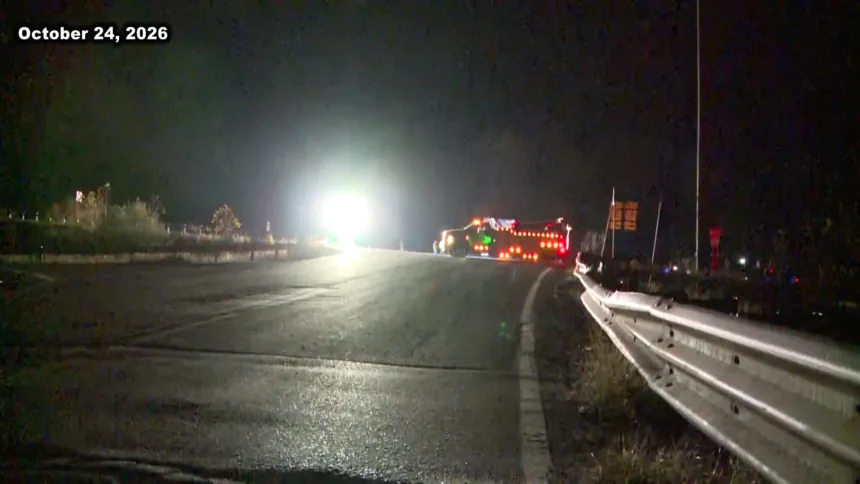 A sheriff's vehicle near a roadway after a fatal crash investigation involving a coal truck