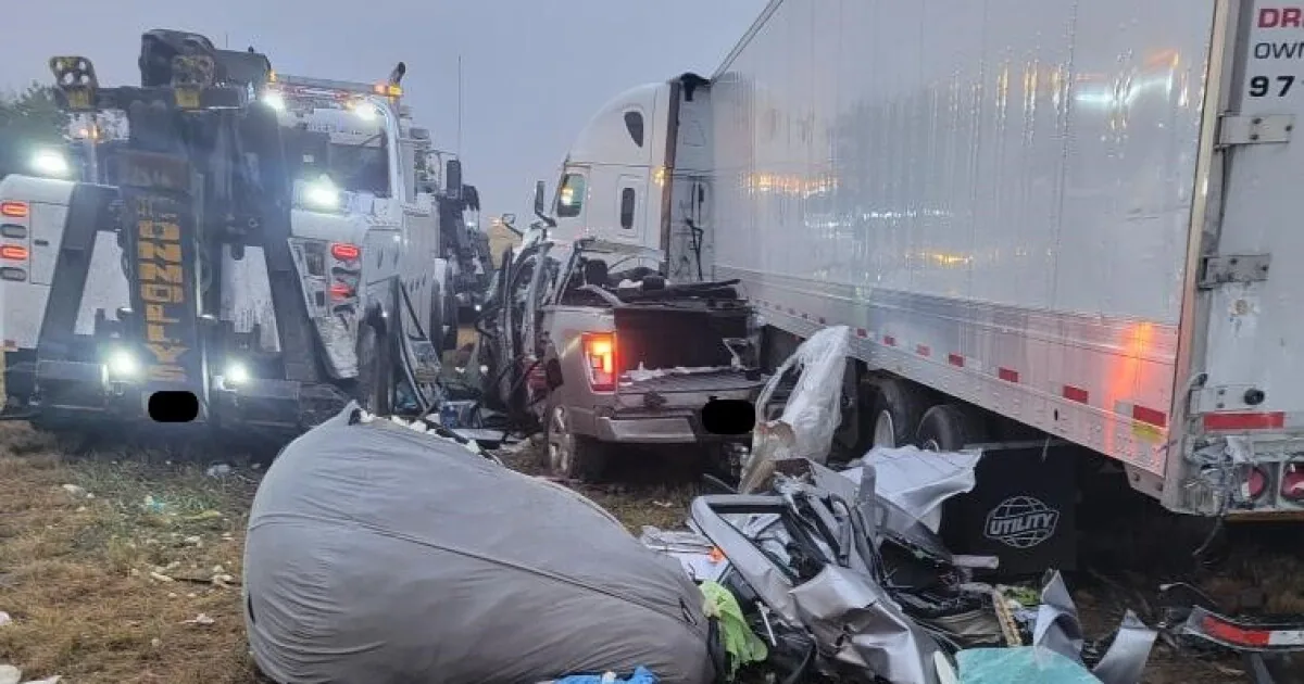 Colorado State Patrol vehicle near an Interstate 70 crash scene with tow trucks working on a semi