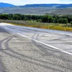Police investigate a burned head-on crash scene along Colorado Highway 9