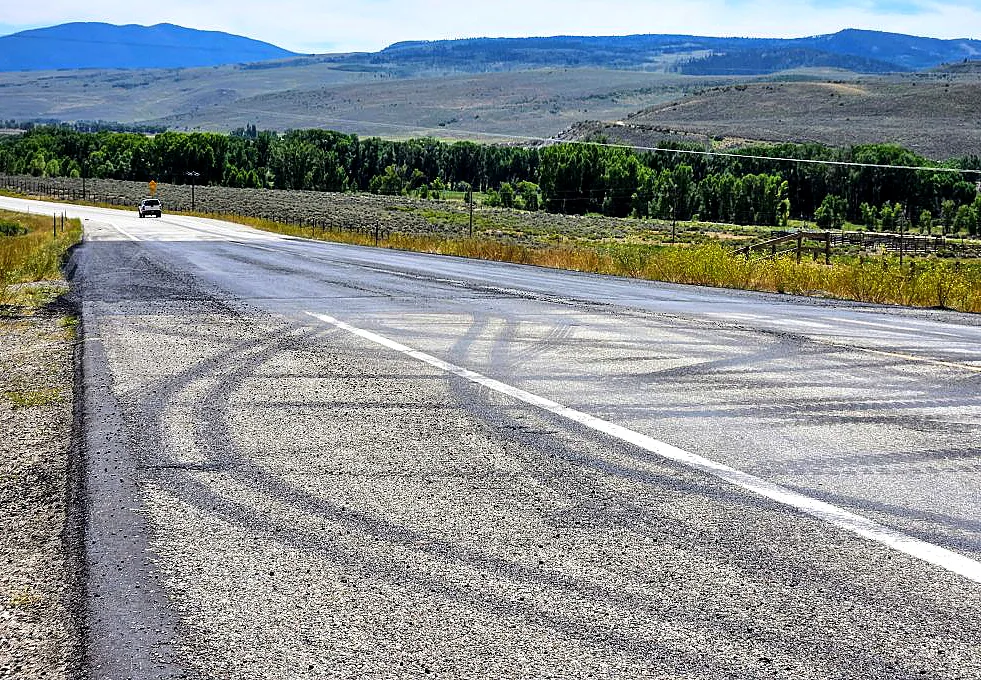Police investigate a burned head-on crash scene along Colorado Highway 9