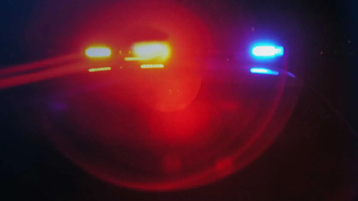 Two semitrucks on an interstate lane beside a police vehicle during a highway chase